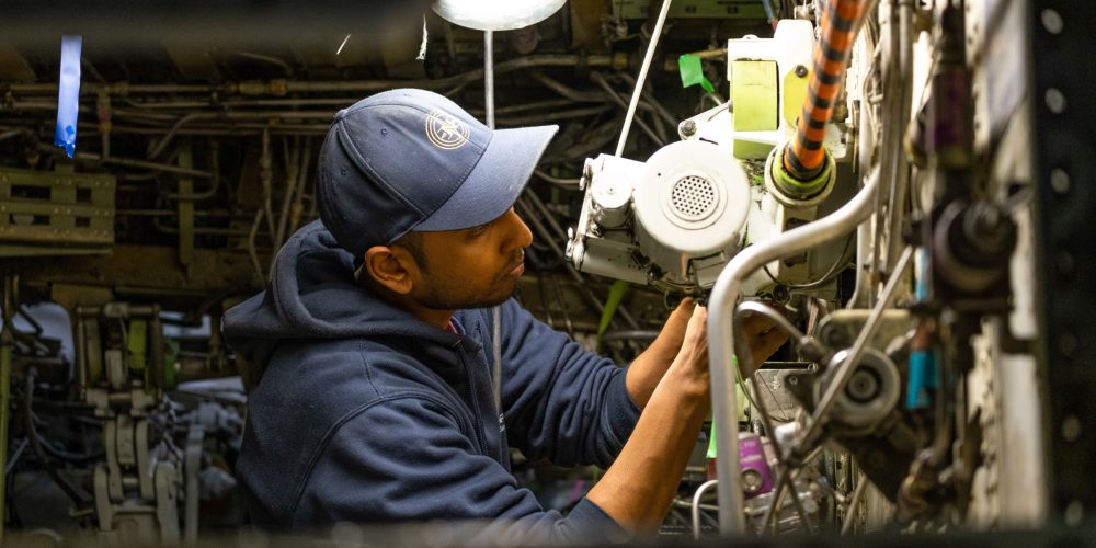 A Nolinor Aviation maintenance technician repairs a Boeing 737.